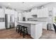 Spacious kitchen featuring a large island, modern appliances, white cabinets, and stylish pendant lighting at 6535 Bridgemoor Dr, Indian Trail, NC 28079