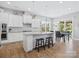 Open kitchen with a large island, stainless steel appliances, and a dining area with natural light at 6535 Bridgemoor Dr, Indian Trail, NC 28079