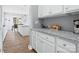 Bright kitchen with granite counters, white cabinetry, and modern appliances at 6535 Bridgemoor Dr, Indian Trail, NC 28079