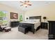 Spacious main bedroom with a king bed, dark wood furniture, ceiling fan, and view to the backyard at 6535 Bridgemoor Dr, Indian Trail, NC 28079