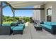 Inviting covered patio with comfortable outdoor seating, overlooking beautifully landscaped backyard at 6535 Bridgemoor Dr, Indian Trail, NC 28079
