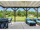 Covered patio with comfortable outdoor seating that overlooks a grassy backyard and storage shed at 6535 Bridgemoor Dr, Indian Trail, NC 28079