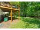 Shaded backyard with a well-maintained lawn, patio and exterior supports at 7018 Rollingridge Dr, Charlotte, NC 28211