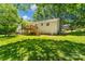 The home has a large backyard with a wooden deck accessible by stairs and a well-maintained lawn at 7018 Rollingridge Dr, Charlotte, NC 28211