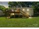 Home's backyard with a deck, grill, and well-maintained lawn at 7018 Rollingridge Dr, Charlotte, NC 28211