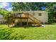 Home's backyard with a deck, grill, and well-maintained lawn during daylight hours at 7018 Rollingridge Dr, Charlotte, NC 28211
