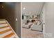 Finished basement with fireplace and neutral furniture at 7018 Rollingridge Dr, Charlotte, NC 28211