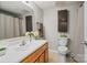 Well-lit bathroom with vanity, mirror, toilet, neutral walls and tile flooring at 7018 Rollingridge Dr, Charlotte, NC 28211