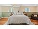 Finished basement bedroom with wooden flooring and two windows at 7018 Rollingridge Dr, Charlotte, NC 28211