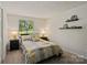 Cozy bedroom features a large window providing ample natural light and view of the outdoors at 7018 Rollingridge Dr, Charlotte, NC 28211