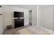 Bright bedroom with a large television, closet, and neutral walls at 7018 Rollingridge Dr, Charlotte, NC 28211