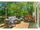 Spacious outdoor deck featuring a comfortable seating area and a firewood rack at 7018 Rollingridge Dr, Charlotte, NC 28211