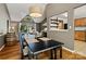 Spacious dining room with a view into the living room and a barrel accent piece at 7018 Rollingridge Dr, Charlotte, NC 28211