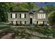 Charming two-story home with light yellow siding, black shutters, and manicured front yard at 7018 Rollingridge Dr, Charlotte, NC 28211