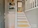 Inviting foyer featuring a staircase with white rails and light wood treads at 7018 Rollingridge Dr, Charlotte, NC 28211