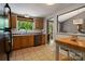 Functional kitchen featuring oak cabinets, neutral countertops, and views to the outdoor area at 7018 Rollingridge Dr, Charlotte, NC 28211