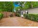 Spacious backyard with lush greenery, a wooden deck, and a brick exterior, perfect for outdoor entertaining at 7022 Lakeside Dr, Charlotte, NC 28215