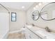 Well-lit bathroom features a double sink vanity, a tub, and modern fixtures with a tile floor at 7022 Lakeside Dr, Charlotte, NC 28215