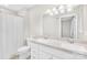 Bathroom features double sink vanity, a large mirror, and a shower with a curtain at 7022 Lakeside Dr, Charlotte, NC 28215