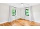 Inviting bedroom showcasing hardwood floors, natural lighting, and a tranquil view from the window at 7022 Lakeside Dr, Charlotte, NC 28215