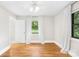 Cozy bedroom boasts hardwood floors, neutral decor, and a well-lit ambiance from a large window at 7022 Lakeside Dr, Charlotte, NC 28215