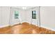 Sunlit bedroom featuring hardwood floors, neutral walls, and ample natural light from two windows at 7022 Lakeside Dr, Charlotte, NC 28215