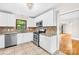 Updated kitchen boasts stainless steel appliances, granite countertops, and bright white cabinetry at 7022 Lakeside Dr, Charlotte, NC 28215