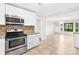 Bright, open kitchen featuring stainless appliances, granite counters, and seamless flow to living area at 7022 Lakeside Dr, Charlotte, NC 28215