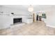 Living room showcasing fireplace, tile floors and adjacent kitchen at 7022 Lakeside Dr, Charlotte, NC 28215