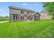 Well-maintained backyard with a large lawn, patio, and mature trees at 8070 Clems Branch Rd, Indian Land, SC 29707