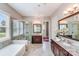 Luxurious bathroom with a soaking tub, a glass shower, and dual vanities with granite countertops at 8070 Clems Branch Rd, Indian Land, SC 29707