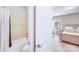 Bathroom with a shower-tub combo and stylish tile work, open to bedroom with natural lighting at 8070 Clems Branch Rd, Indian Land, SC 29707