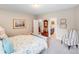 Comfortable bedroom with ensuite bathroom, soft carpet, and a cozy accent chair at 8070 Clems Branch Rd, Indian Land, SC 29707