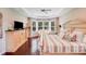 Inviting bedroom with a sitting area, hardwood floors, and a tray ceiling at 8070 Clems Branch Rd, Indian Land, SC 29707