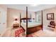Bedroom featuring a four-poster bed, decorative rug, and a window for natural light to enjoy this private retreat at 8070 Clems Branch Rd, Indian Land, SC 29707