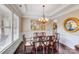 Open dining area with chandelier, large picture window and crown molding at 8070 Clems Branch Rd, Indian Land, SC 29707