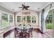 Bright dining area features hardwood floors, a glass table, a ceiling fan, and lots of natural light at 8070 Clems Branch Rd, Indian Land, SC 29707