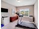 Exercise room with a treadmill by a window and a small dresser, offering a dedicated workout space at 8070 Clems Branch Rd, Indian Land, SC 29707