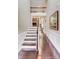 Spacious foyer with staircase leading to the upper level, hardwood floors, and wainscoting at 8070 Clems Branch Rd, Indian Land, SC 29707