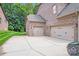 Attached three-car garage with ample parking and storage space with paved driveway at 8070 Clems Branch Rd, Indian Land, SC 29707