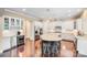 Modern kitchen with stainless steel appliances, granite countertops, island seating, and hardwood floors at 8070 Clems Branch Rd, Indian Land, SC 29707