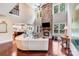 Inviting living room features a stone fireplace, high ceilings, lots of natural light, and hardwood floors at 8070 Clems Branch Rd, Indian Land, SC 29707