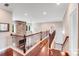 Open living space with hardwood floors, a stone fireplace, and a railing overlooking the lower level at 8070 Clems Branch Rd, Indian Land, SC 29707