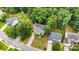 Aerial view of a home with well-maintained landscaping and mature trees in a quiet neighborhood at 8256 Chatham Oaks Dr, Concord, NC 28027