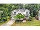 Lovely home, surrounded by mature trees, features a long driveway and a meticulously kept yard in a serene setting at 8256 Chatham Oaks Dr, Concord, NC 28027