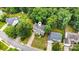 An aerial view showing the landscaped yard, driveway, and surrounding trees of the property at 8256 Chatham Oaks Dr, Concord, NC 28027