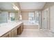 Bright bathroom with tub, glass shower and double sink vanity at 8256 Chatham Oaks Dr, Concord, NC 28027