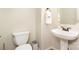 Half bathroom with pedestal sink, neutral wall color and modern toilet at 8256 Chatham Oaks Dr, Concord, NC 28027