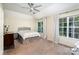 Cozy bedroom with carpet, ceiling fan, and natural light from the windows at 8256 Chatham Oaks Dr, Concord, NC 28027