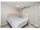 This bedroom has neutral walls, a ceiling fan, and a window to let natural light fill the space at 8256 Chatham Oaks Dr, Concord, NC 28027